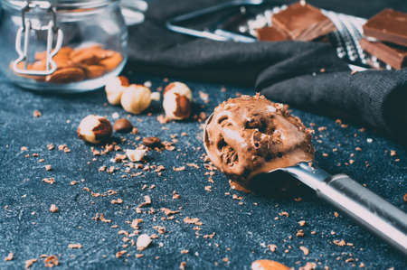 Chocolate ice cream on the spoon and ingredients over dark background concreteの写真素材