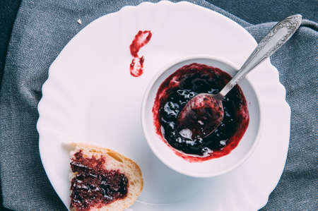 Bread and jam from a black currantの写真素材
