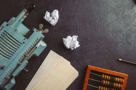 The old computing machine and wooden abacus. The concept of accountingの写真素材