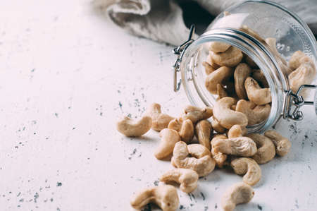 Cashew nuts in a jar on the old tableの写真素材