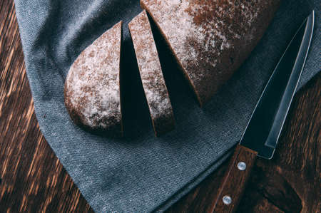 Rye bread and knife on dark backgroundの写真素材
