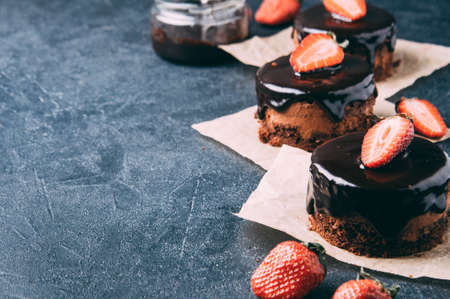 Chocolate cupcakes with strawberries on a dark backgroundの写真素材