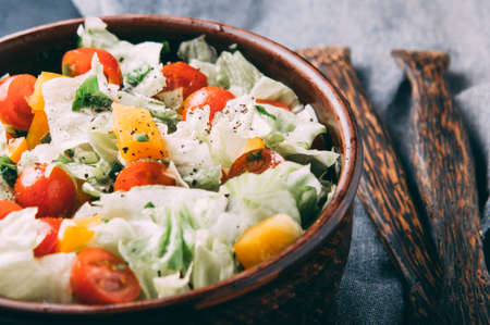 The coleslaw and tomatoes on the table. The dark styleの写真素材