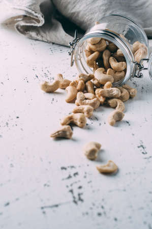 Cashew nuts in a jar on the old tableの写真素材