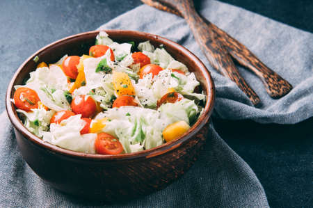 The coleslaw and tomatoes on the table. The dark styleの写真素材