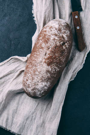 Rye bread and knife on dark backgroundの写真素材