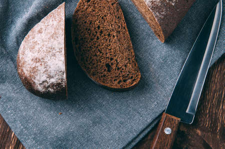 Rye bread and knife on dark backgroundの写真素材