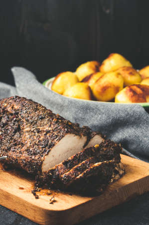 Grilled Turkey tenderloin and potatoes on a wooden cutting Boardの写真素材