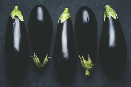 Eggplant on dark concrete background. Top view and flat layの写真素材