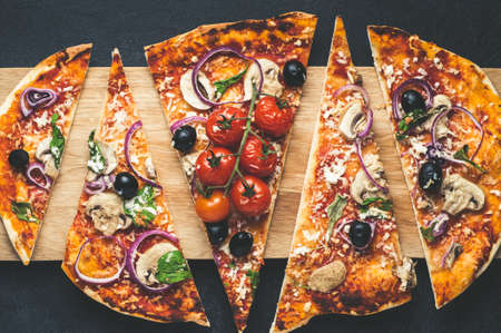 Homemade pizza on cutting Board over dark concrete backgroundの写真素材