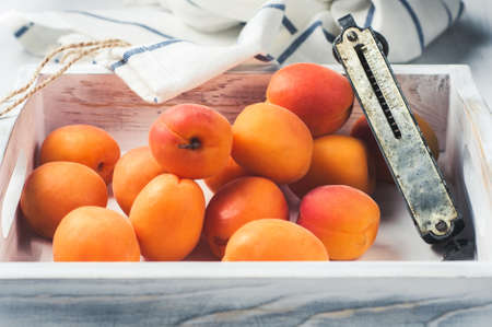 Fresh apricots in a white wooden boxの写真素材