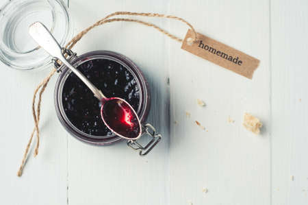 Homemade jam in a jar over white wooden backgroundの写真素材