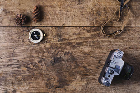 Retro camera and compass on a wooden background. Travel conceptの写真素材
