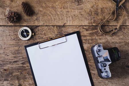 Retro camera and compass on a wooden background. Travel conceptの写真素材