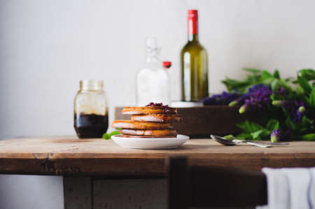 Bread and jam on an old wooden table. A still life with lupines and wareの写真素材
