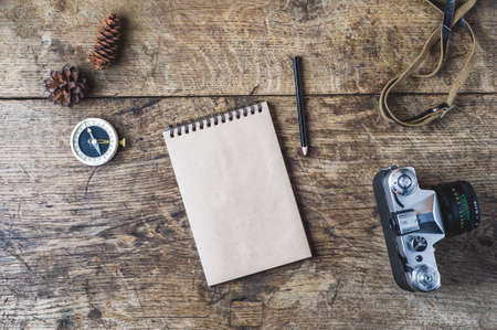 Retro camera and compass on a wooden background. Travel conceptの写真素材