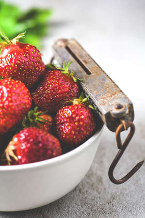 Fresh strawberries in a Cup on a gray concrete backgroundの写真素材