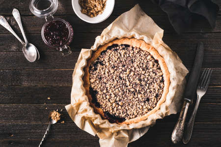 Fresh homemade jam pie on a dark wooden backgroundの写真素材