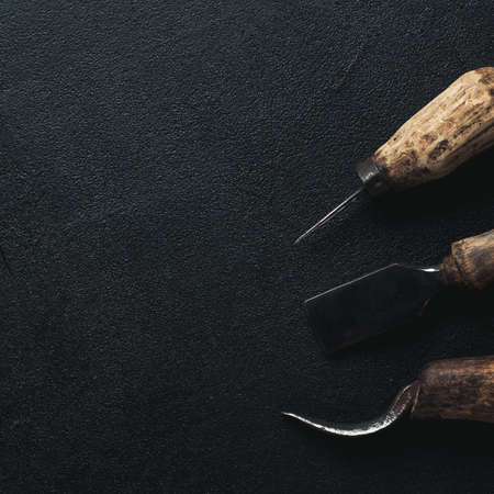 Old and rusty tools on a black concrete backgroundの写真素材