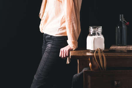 Woman near a kitchen table with ingredients for cooking
