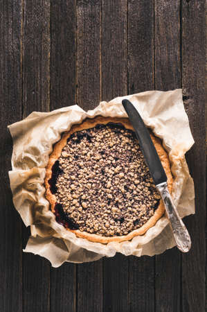 Fresh homemade jam pie on a dark wooden background