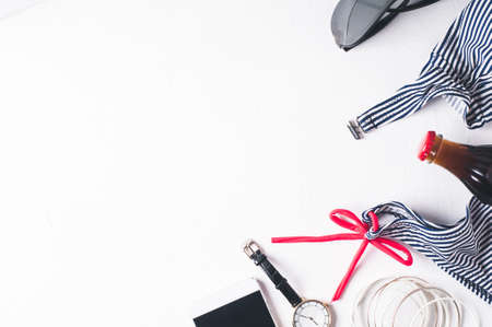 Retro style striped swimsuit and fashion accessories  on a white concrete backgroundの写真素材