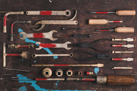 A set of old tools for the professional mechanic over old wooden background