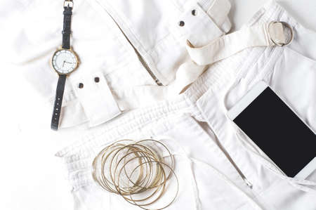 White womens clothing and fashion accessories on a white concrete backgroundの写真素材