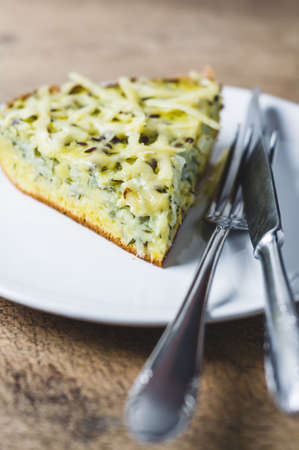 Portion of homemade cabbage pie and cheese on a white plateの写真素材