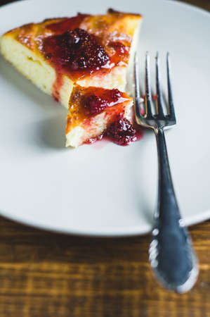 Portion of homemade pie with strawberry jam in a grey ceramic plate