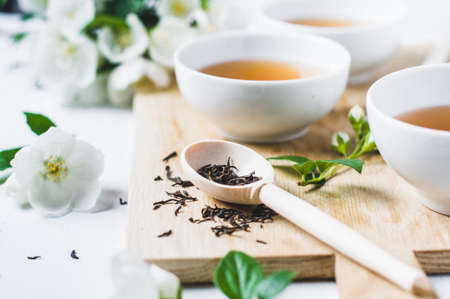 Green tea with a jasmine in white cupsの写真素材