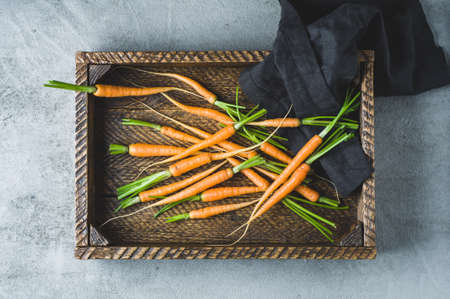 Fresh carrots in an old wooden boxの写真素材