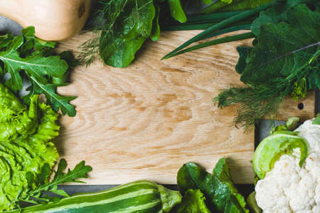 Vegetables frame with cutting board in the centre of compositionの写真素材