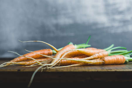 Fresh carrots on a wooden table. Copy space for text or designの写真素材