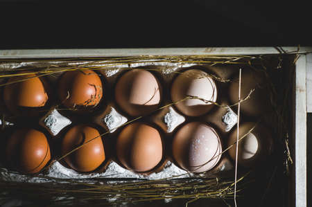 Chicken eggs in a wooden box. Dark style shotの写真素材