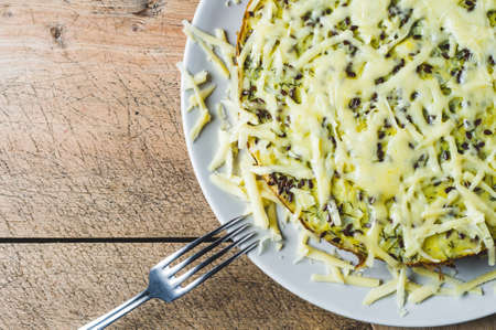 Homemade cabbage pie and cheese on an old wooden tableの写真素材