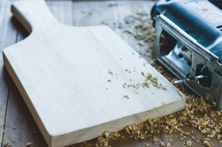 Jigsaws and shavings on wooden background. Woodworking or carpentry conceptの写真素材