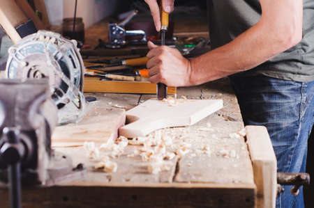 Carpenter with tools at work in the workshopの写真素材