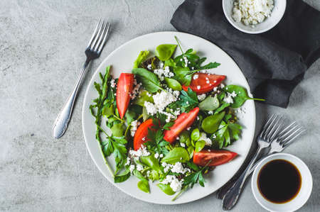 Fresh tomato salad in a grey ceramic plate. Diet or clean eating conceptの写真素材