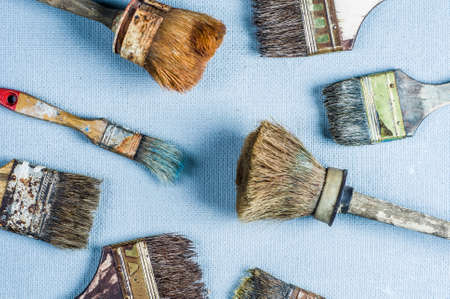 Old and dirty paint brush on a gray backgroundの写真素材