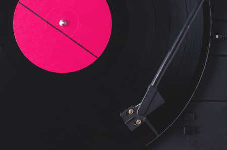 Vinyl record with red label and old playerの写真素材