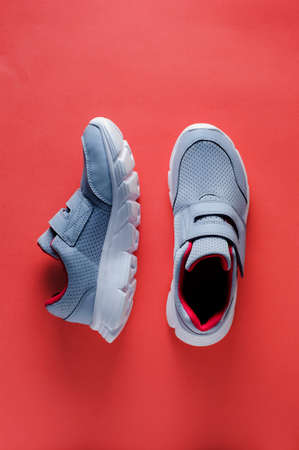 Grey sneakers on pink background. Flat lay and top viewの写真素材