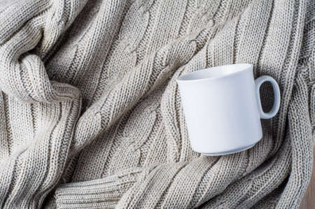 White mug on a textile background. Template for text or designの写真素材