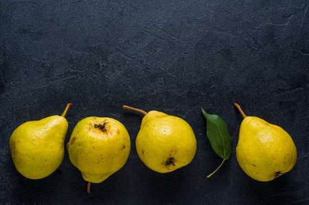 Ripe yellow pear on a dark background