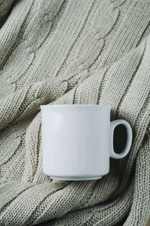 White mug on a textile background. Template for text or designの写真素材