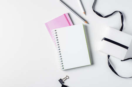 Gift box and notebooks on a light backgroundの写真素材