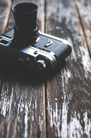 Old camera on dark wooden backgroundの写真素材