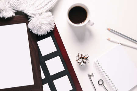Photo frame and coffee on the table. Flat lay and top view. Template for text or designの写真素材