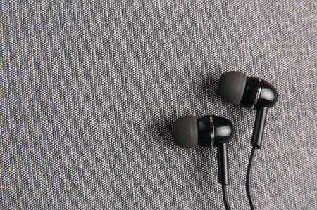 Black headphones on grey background