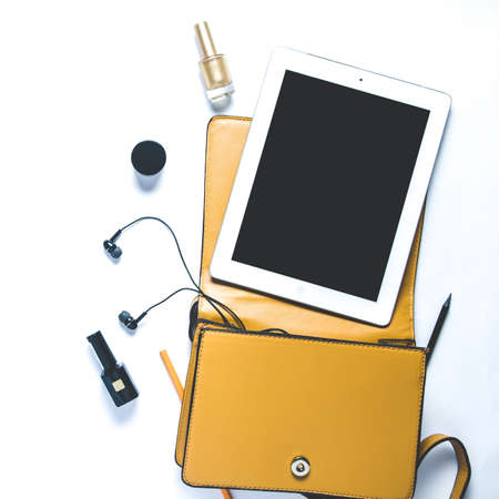 Women's handbag and accessories on white background. Flat lay and top view